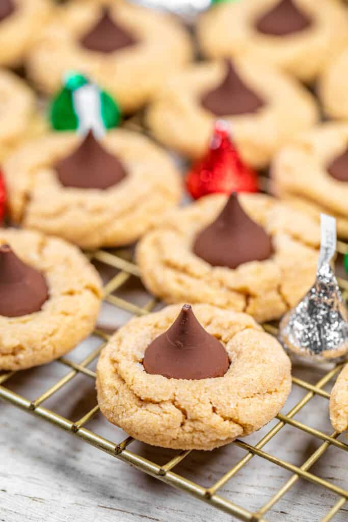 peanut butter cookies topped with a hershey kiss on a cooling rack