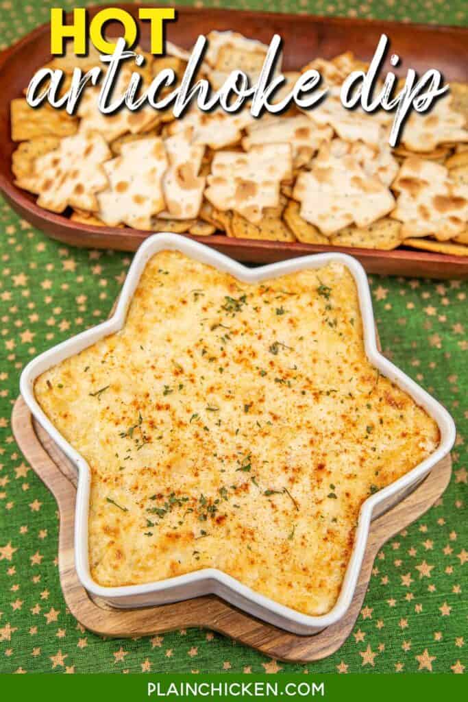 baking dish of artichoke cheese dip with crackers in a basket with text overlay