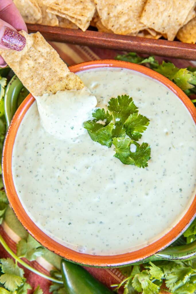 dipping chip into jalapeno dip