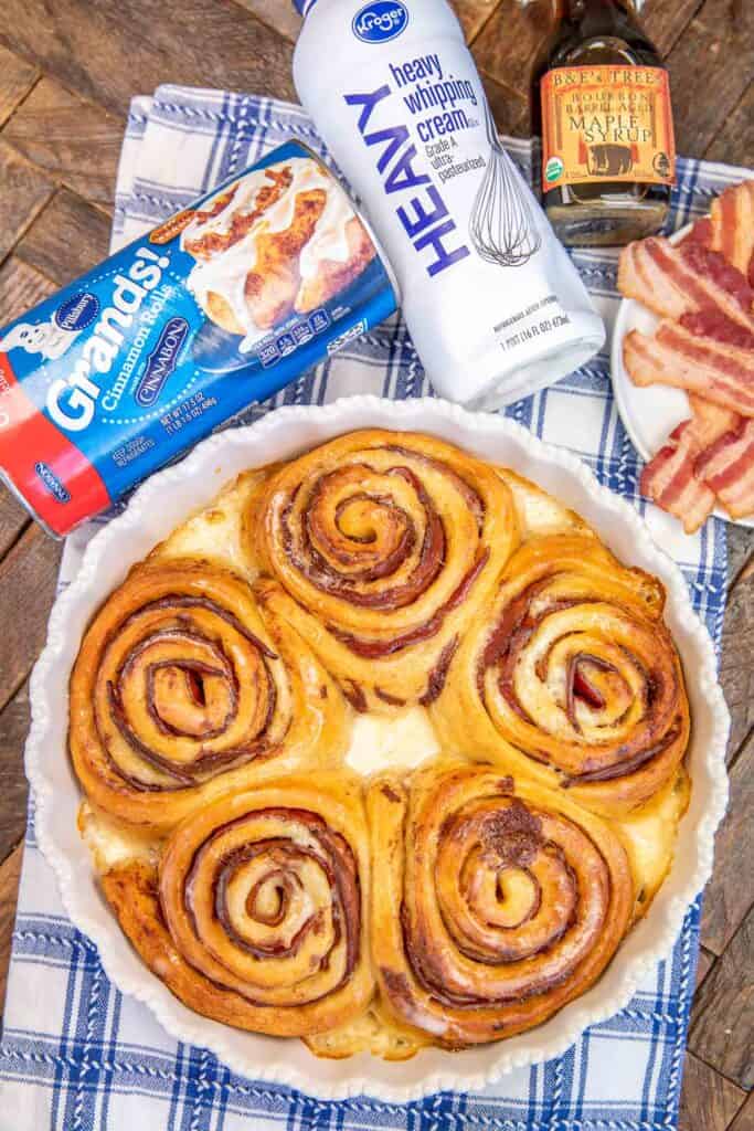 pan of cinnamon rolls with ingredients in the background
