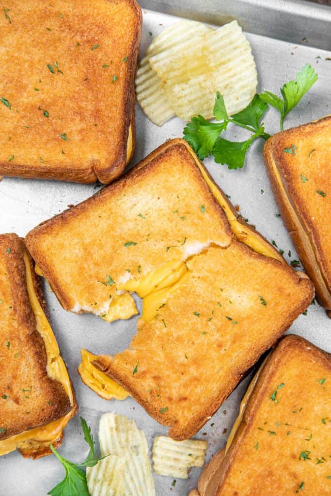 crispy grilled cheese sandwiches on a baking sheet