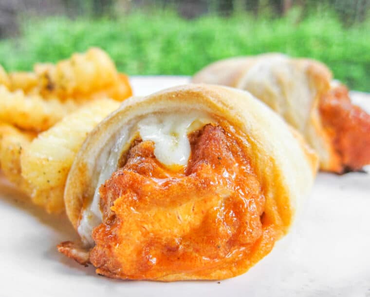 buffalo chicken crescent rolls on a plate with fries