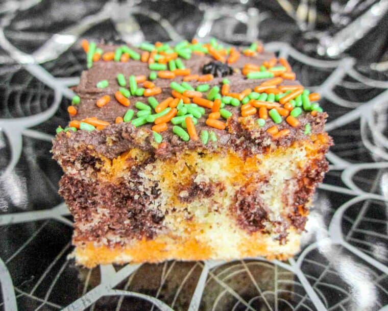 slice of halloween poke cake with sprinkles