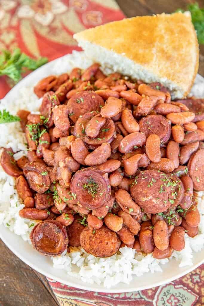 plate of red beans and rice with cornbread in the back