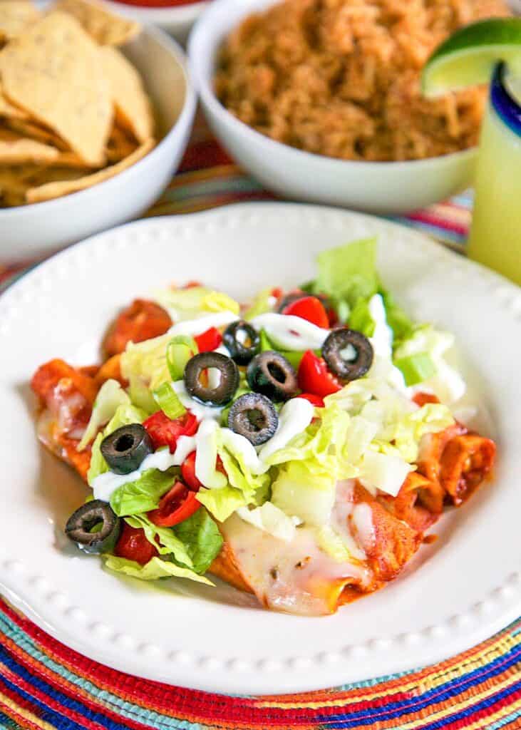 plate of lazy enchiladas topped with lettuce, olives, and tomatoes