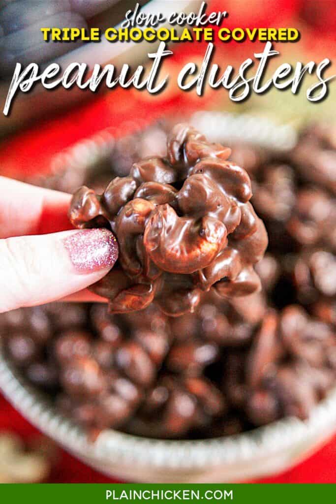 holding a chocolate covered peanut cluster