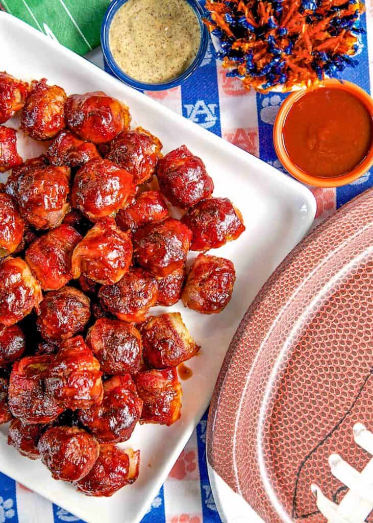 plate of bacon wrapped bbq meatballs on a tailgating table