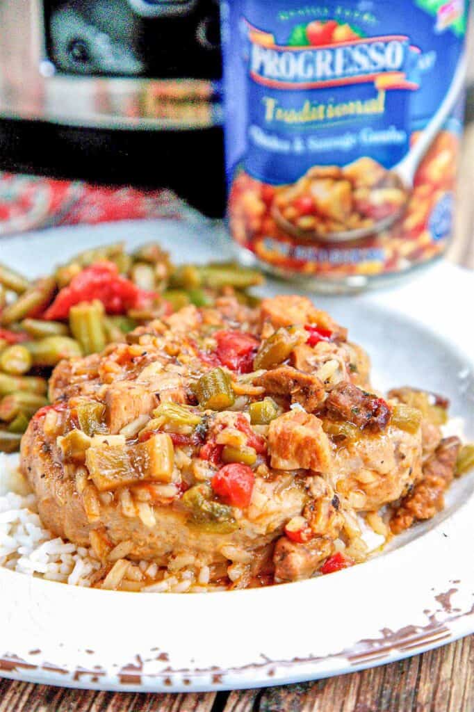 smothered pork chops on a plate with green beans