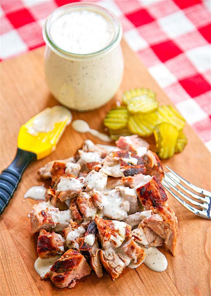 chopped pork with white sauce drizzled over it