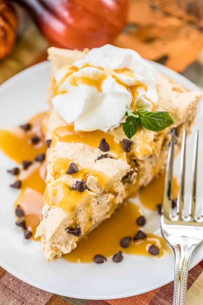slice of pumpkin pie on plate with whipped cream