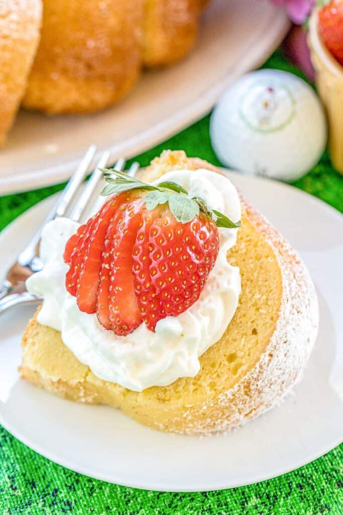 slice of pound cake topped with whipped cream and strawberries