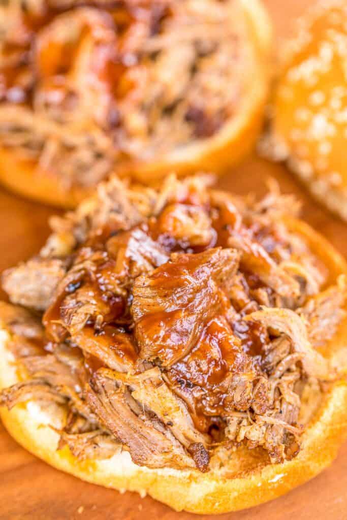 pulled pork sandwiches topped with bbq sauce on a platter
