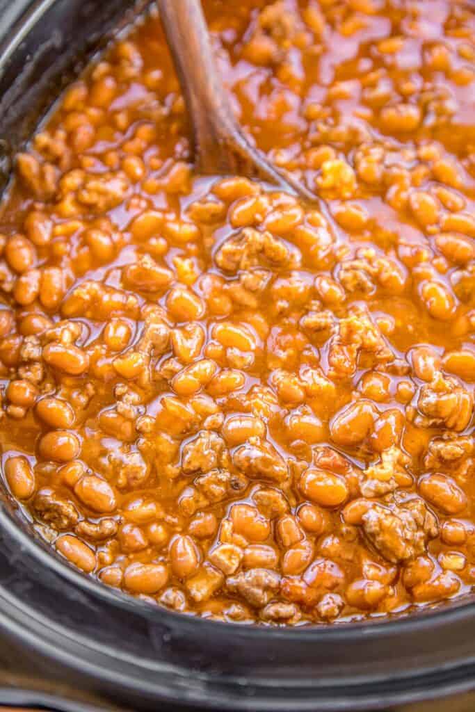 stirring a pot of beans in the slow cooker