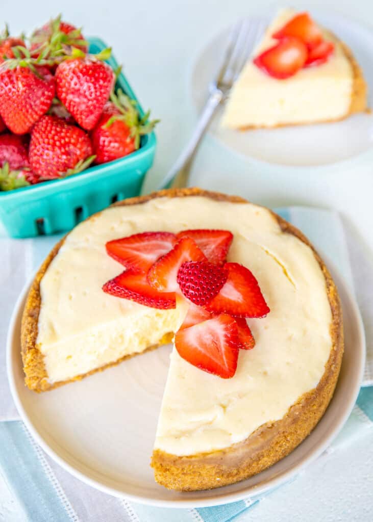 sliced cheesecake topped with strawberries