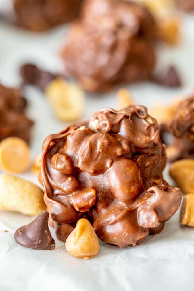 chocolate peanut clusters on parchment paper