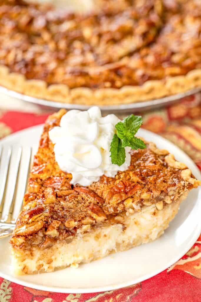 slice of pecan cheesecake pie on a plate with a fork