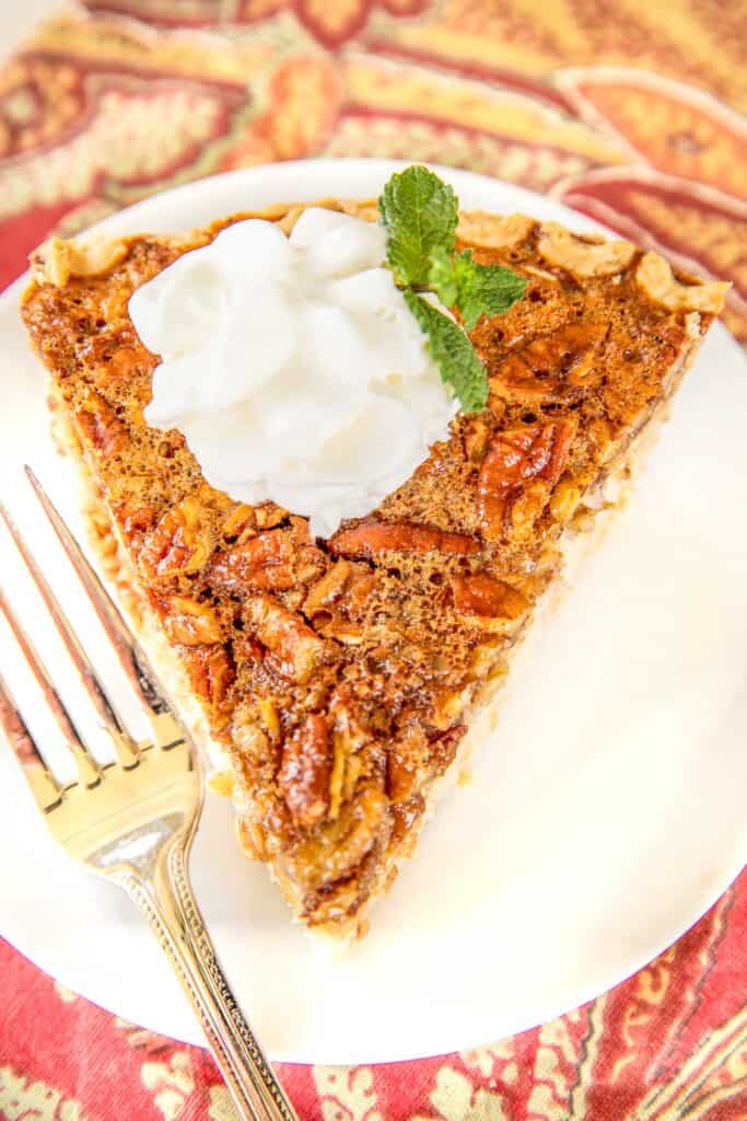 slice of pecan cheesecake pie on a plate with a fork