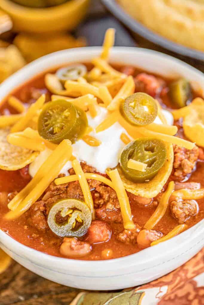 bowl of chili topped with cheese and jalapenos