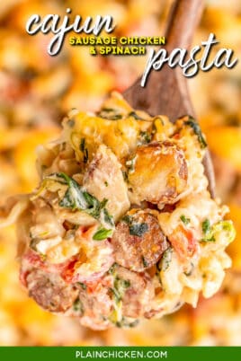 spoonful of pasta casserole with sausage, chicken, and spinach