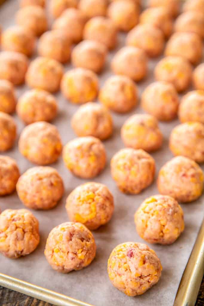 unbaked sausage balls on a cookie sheet