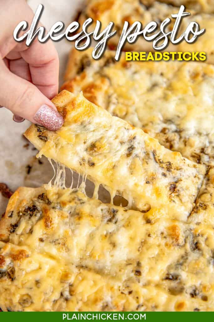 pulling cheese breadstick from baking sheet