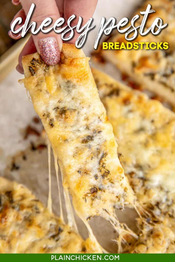 pulling cheese breadstick from baking sheet