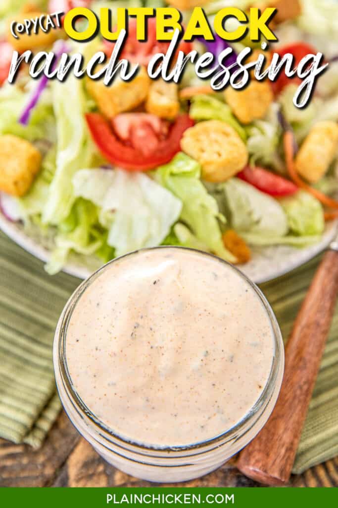 jar of outback ranch dressing with a salad in the background