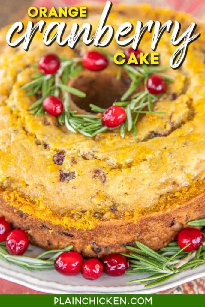 orange cake with cranberries and rosemary on a platter