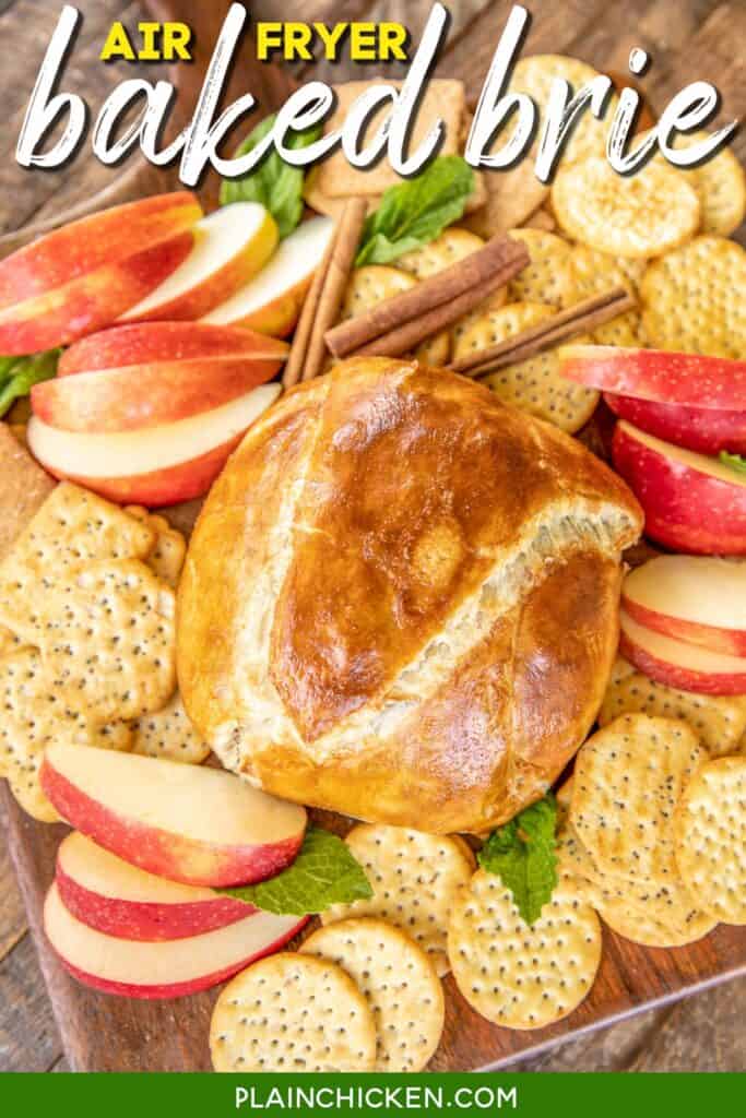 Baked brie on a platter with crackers and apples