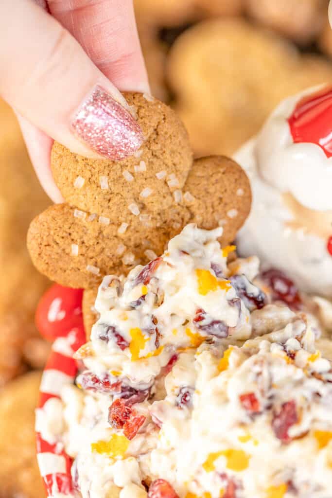 dipping cookie into cream cheese cranberry dip
