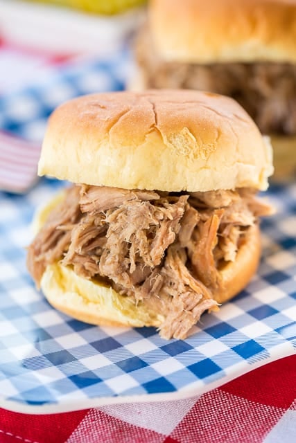 3-Ingredient Pulled Pork - slow cooked pork shoulder that is better than any restaurant! Great on hamburger buns, on top of a baked potato, nachos or a salad. All you need is some slaw and baked beans and you are all set. Easy peasy party! You can also freeze the leftovers for later.