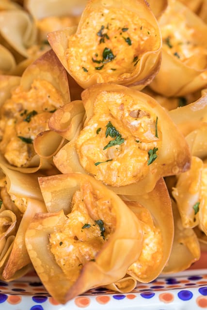 Buffalo Chicken Bites - creamy buffalo chicken dip baked in wonton wrappers. PERFECT for parties and tailgating!! I love these bite-sized appetizers!! Can adjust hot sauce to make the dip fit your tastes. Everyone RAVES about this yummy appetizer recipe! Always gone in a flash!