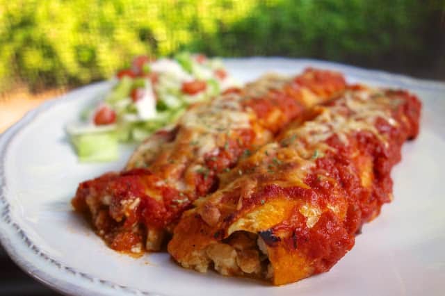 Chicken Parmesan Enchiladas - SO good!! Chicken, cottage cheese, mozzarella, parmesan cheese, egg and parsley wrapped in flour tortillas and topped with spaghetti sauce. Fun twist on our usual manicotti! YUM! #chicken #casserole
