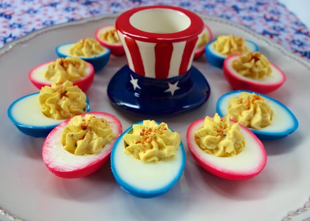 Patriotic Deviled Eggs - CRAZY good deviled eggs. Eggs, mayonnaise, vinegar, salt, dry mustard, pepper, onion and paprika. Dye the hard boiled eggs red and blue for a fun patriotic snack!