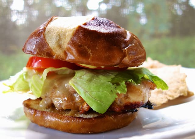 Creole Honey Mustard Chicken Sandwich Recipe - chicken marinated in dijon mustard, honey, lemon juice and cajun seasoning - grill or pan sear chicken, top with cheese and serve on a pretzel bun. This is my favorite chicken sandwich - better than any restaurant!
