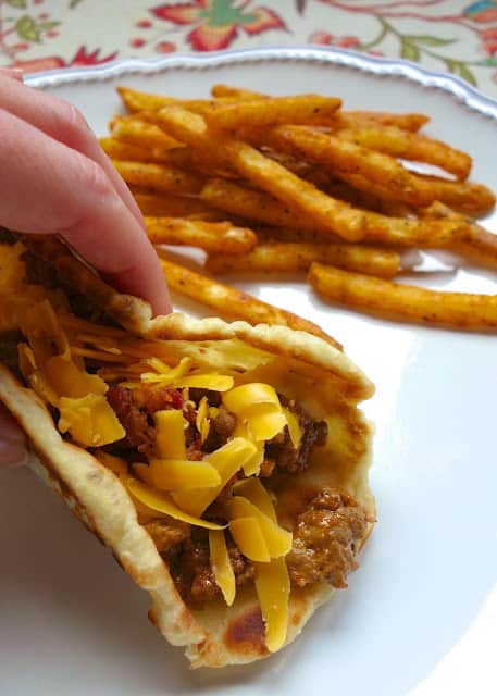 Burger night is sure to be a hit again in your house when you make this Bacon Cheeseburger Flatbread recipe - quick seasoned hamburger meat served on top of a homemade flatbread. These are SO good! The whole family gobbled them up!