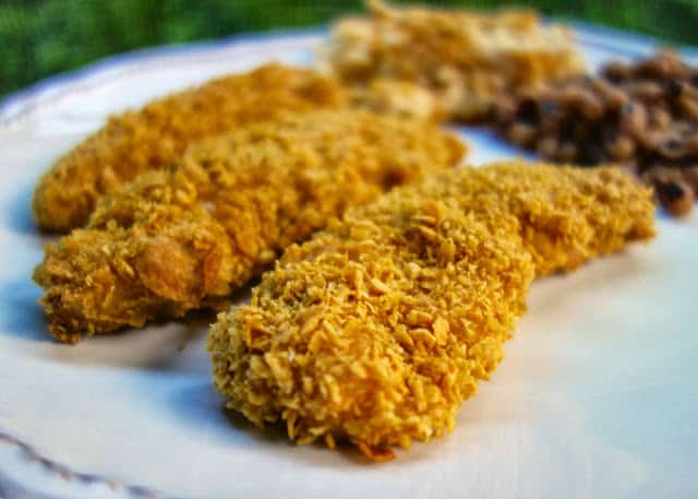 Maple Cornflake Chicken Fingers Recipe - chicken tenders crusted in corn flakes, cajun seasoning and maple syrup - quick dinner recipe - can coated chicken and freeze unbaked for a quick meal later.