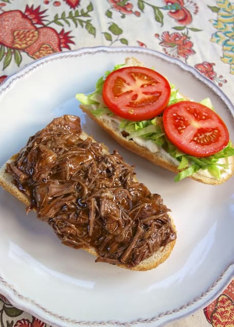 Slow Cooker New Orleans Roast Beef Po-Boy - inspired by our meal at Felix's in New Orleans. Only 5 ingredients! Slow cooked pot roast seasoned with cajun seasoning and simmered in an easy gravy. Can serve as a sandwich or over rice, noodles or mashed potatoes. This stuff is SO good!! Better than the original!