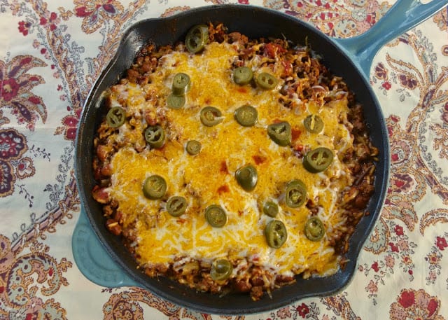 One Pot Skillet Chili and Rice - everything cooks in the same skillet! Ground beef, tomatoes, chili beans, rice, water, tomato paste, cheese and jalapeños - ready in 20 minutes! Great quick and easy weeknight meal!