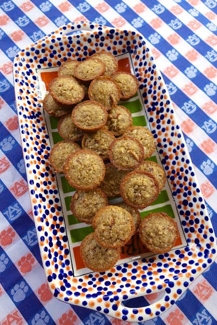 Pecan Pie Muffins - tastes just like pecan pie in muffin form! SO easy! Everyone LOVES these yummy muffins. Pecans, flour, vanilla, brown sugar, butter and eggs. Great for parties, breakfast, brunch and tailgating. Can make a day in advance and store in an air-tight container. Sprinkle with powdered sugar before serving. #muffins #pecan