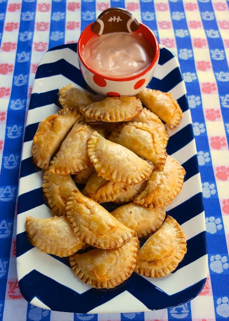 Buffalo Chicken Empanadas - buffalo chicken and cheddar baked in pie crusts - dip in some spicy ranch! These are SOOOO good!! They were the first thing to go at the party. Everyone raved about them!!