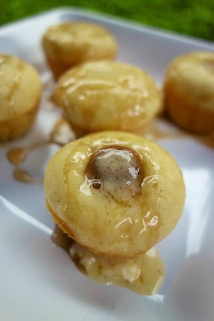 Sausage Pancake Muffins - pigs in a blanket muffins. Homemade pancake batter baked in mini muffin pans with a sausage slice in each muffin. So quick and easy. Great weekday breakfast! Serve with additional maple syrup. YUM!