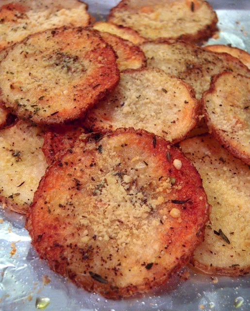 Easy Oven Roasted Potatoes - thinly sliced potatoes oven roasted with Italian seasoning and parmesan cheese -  so good and crispy. My favorite way to make potatoes!