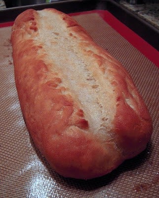 Homemade Baguette - on the table in under an hour! Only 5 ingredients!!! Water, yeast, sugar, flour and salt. So simple and it tastes delicious! Great weeknight homemade bread recipe. #bread #yeast #quickbread