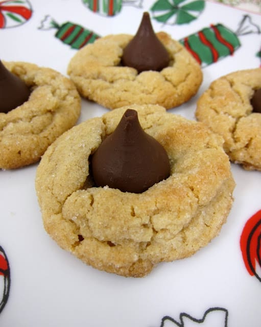 Peanut Butter Kisses - a classic holiday cookie. Our best peanut butter cookie topped with a Hershey Kiss. SO good! A must in our house for Christmas! Great for cookie swaps!
