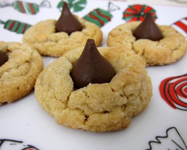 Peanut Butter Kisses - a classic holiday cookie. Our best peanut butter cookie topped with a Hershey Kiss. SO good! A must in our house for Christmas! Great for cookie swaps!