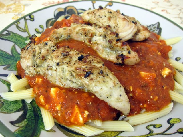 Mediterranean Chicken Pasta - Greek marinated grilled chicken served on top of pasta, marinara and feta. The chicken was so tender and delicious! Everyone loved this simple pasta dish! Serve with a salad and some crusty garlic bread.