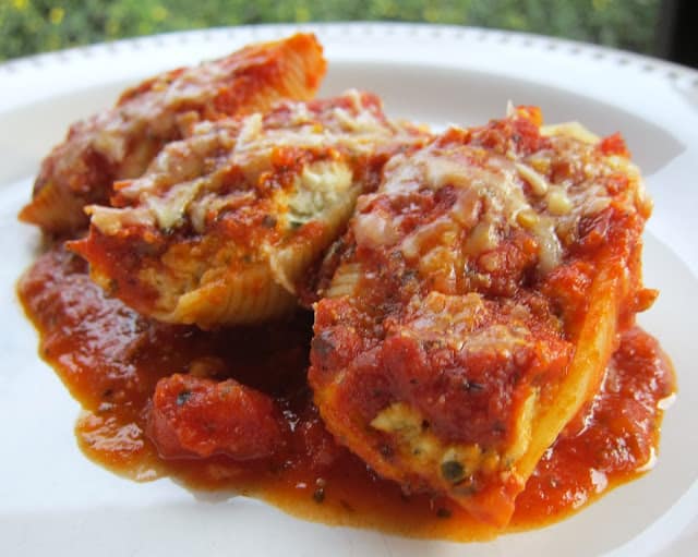 Chicken and Pesto Stuffed Shells - quick and easy weeknight meal. Can make ahead and freezer for later! Jumbo pasta shells stuffed with chicken, ricotta, pesto, mozzarella, garlic, basil. Topped with jarred spaghetti sauce and mozzarella. The whole family LOVES this pasta casserole! #freezermeal #pasta #pastacasserole #casserole