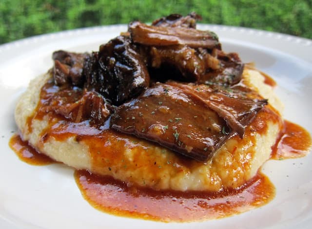 BBQ Pot Roast over Cheddar Ranch Grits - chuck roast slow cooked in a homemade BBQ sauce and served over Quick Cheddar Ranch Grits - this pot roast is SOOO good! I wanted to lick my plate! EVERYONE LOVES this pot roast! 