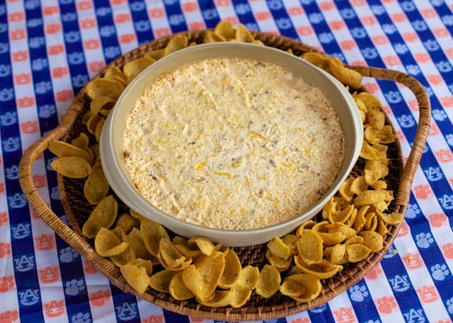 Warm Crack Dip - The ORIGINAL recipe!! Sou cream dip loaded with cheddar, bacon and ranch dip - this stuff is SO addicting! This is always the first thing to go at a party! I could make a meal out of it! Serve with Fritos and tortilla chips! Can make ahead and refrigerate before baking.